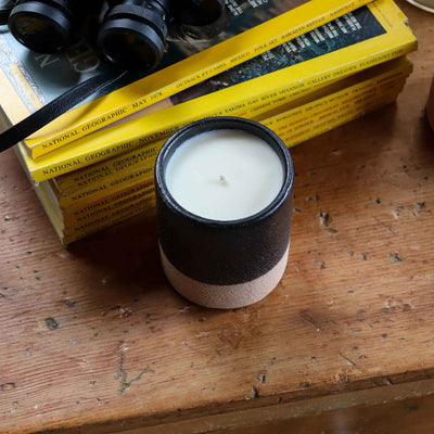 Farmer's Son Candle on desk with books