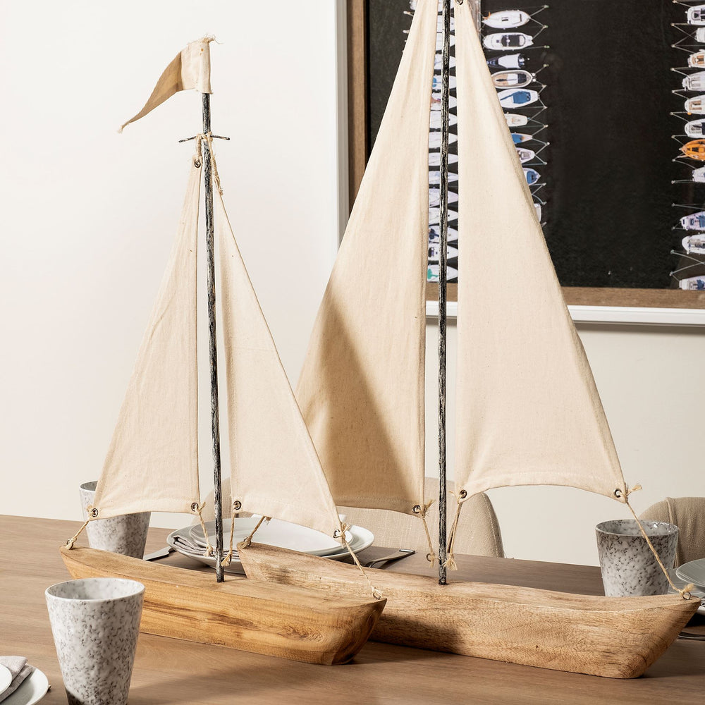 Two tartane sailboats on table